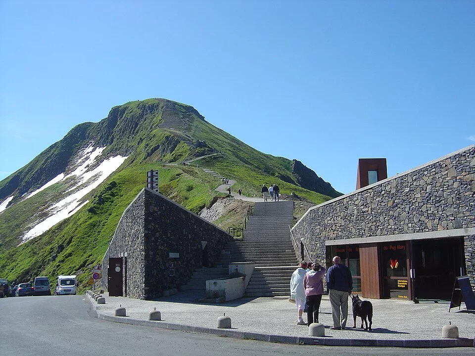The Puy Mary in summer, its pyramid summit and the winding road to the Pas de Peyrol