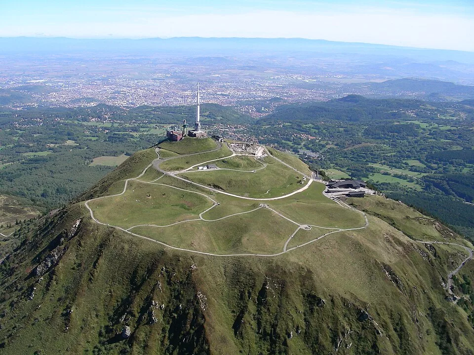 The summit of the Puy de Dôme and its mast, with the Clermont-Ferrand plain in the distance